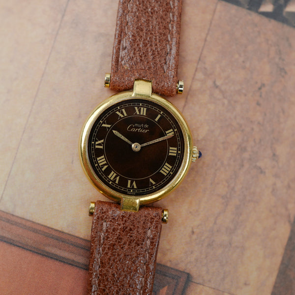 cafe noir les montres vintage horloger marseille CARTIER Vendôme Must ronde Grand Modèle Doré vintage petit modèle ronde patine marron
