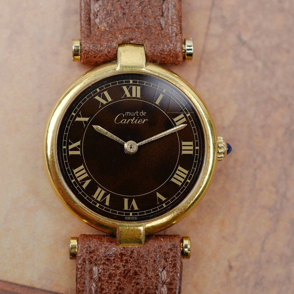 cafe noir les montres vintage horloger marseille CARTIER Vendôme Must ronde Grand Modèle Doré vintage petit modèle ronde patine marron