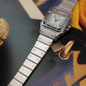Café noir montre vintage Marseille horloger Cartier Santos galbée petit modèle acier automatique 1990