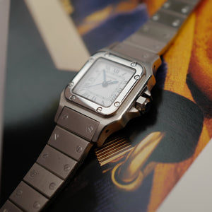 Café noir montre vintage Marseille horloger Cartier Santos galbée petit modèle acier automatique 1990