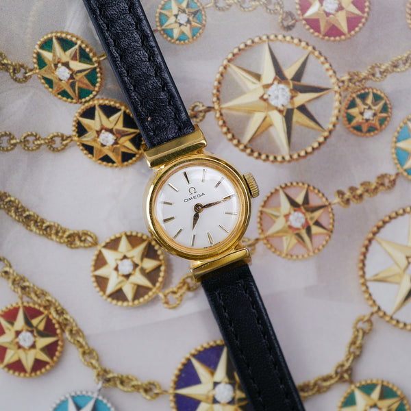 Café noir montres horloger Marseille Omega mini dorée mécanique 1960