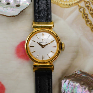 Café noir montres horloger Marseille Omega mini dorée mécanique 1960