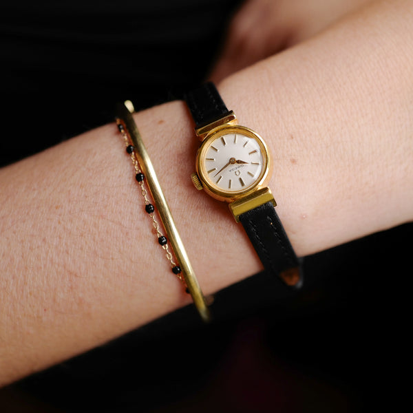 Café noir montres horloger Marseille Omega mini dorée mécanique 1960