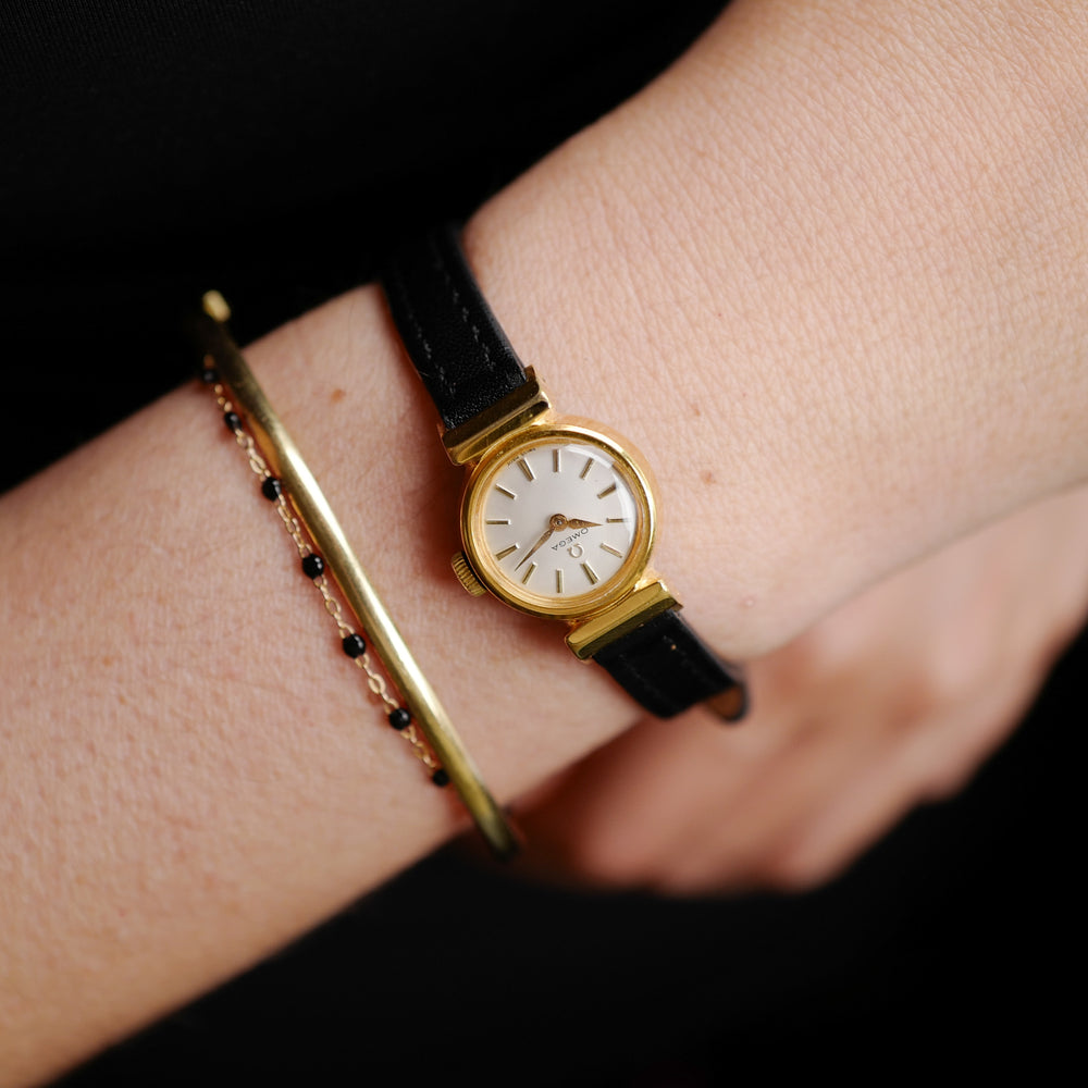 Café noir montres horloger Marseille Omega mini dorée mécanique 1960