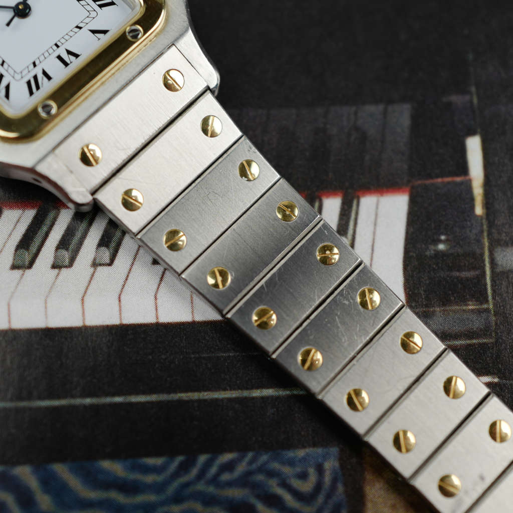 Café Noir Les Montres Marseille Cartier Ellipse femme réf. 67081 bracelet en maille en or jaune 18 carats diamants bracelet serpent commande spéciale vintage 1980 bicolore