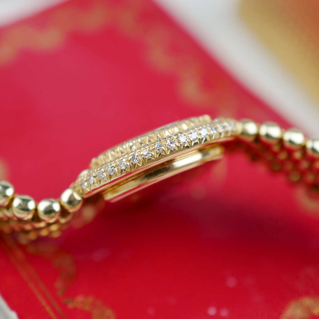 Café Noir Les Montres Marseille Cartier Ellipse femme réf. 67081 bracelet en maille en or jaune 18 carats diamants bracelet serpent commande spéciale vintage 1990