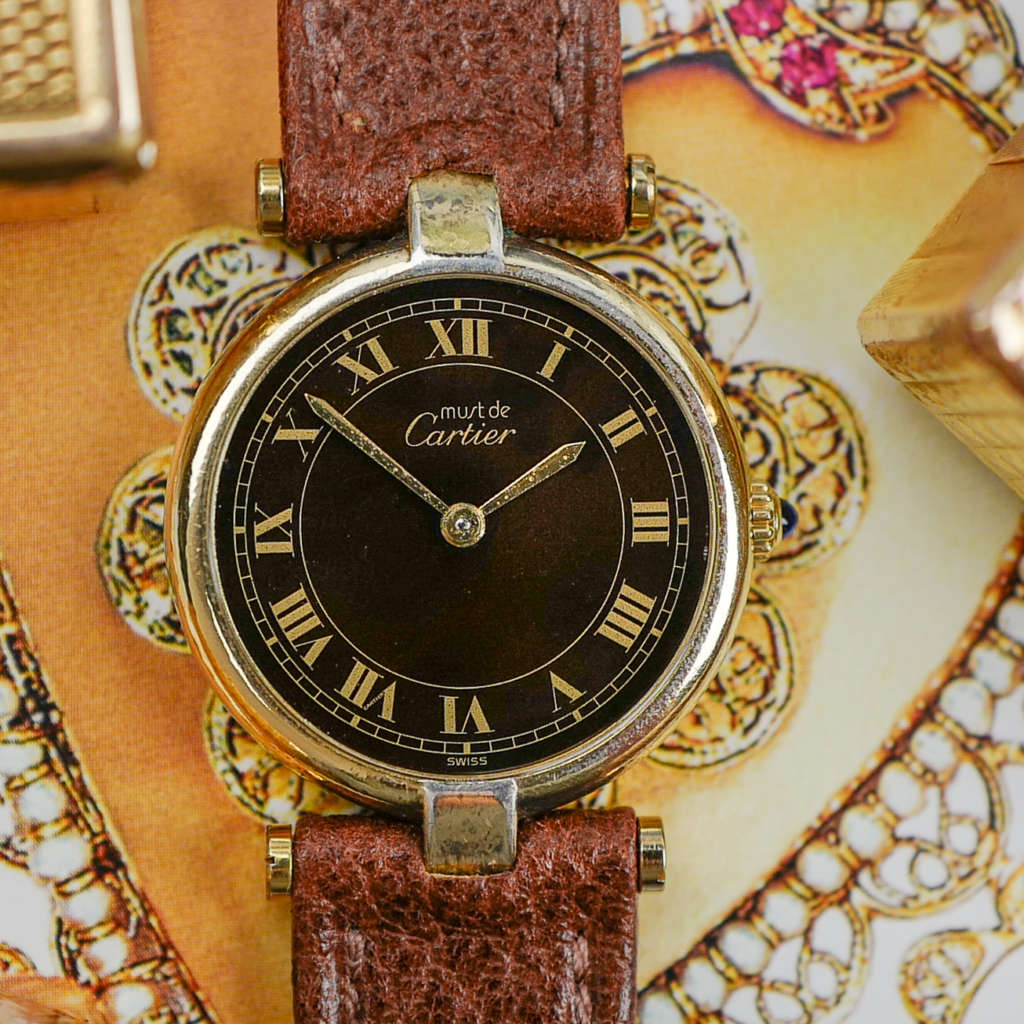 cafe noir les montres vintage horloger marseille CARTIER Vendôme Must ronde Grand Modèle Doré vintage petit modèle ronde patine marron